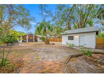 Large backyard with detached garage, fire pit and patio at 505 Jefferson S Ave, Oldsmar, FL 34677