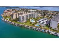 Aerial view of Sunwatch, a waterfront community with tennis courts, pool, and boat slips at 670 Island Way # 500, Clearwater Beach, FL 33767