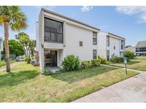 Two-story building exterior, featuring white siding and a balcony at 706 Haven Pl, Tarpon Springs, FL 34689