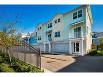 Modern townhouses with attached garages and private balconies at 805 Oak Bend Ln, Dunedin, FL 34698