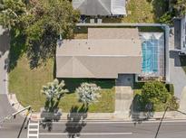 Aerial view of a single-Gathering home with a pool and fenced backyard at 1198 40Th Ne Ave, St Petersburg, FL 33703