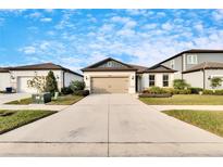 Charming one-story house with a two-car garage, neat lawn, and a welcoming front porch at 12940 Brookside Moss Dr, Riverview, FL 33579