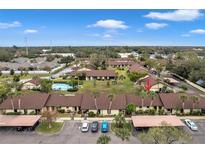 Aerial view of a community with a pool and numerous villas at 1345 Daffodil Pl # 608, Dunedin, FL 34698
