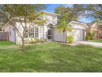 House exterior featuring a well-maintained lawn and a two-car garage at 5301 Watson Rd, Riverview, FL 33578