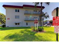 Building exterior showcasing landscaping and parking at 5660 80Th N St # C307, St Petersburg, FL 33709