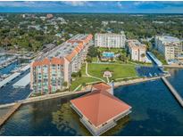 Aerial view of waterfront condo building with pool, dock, and parking at 632 Edgewater Dr # 439, Dunedin, FL 34698