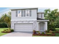 Two-story house with gray siding, stone accents, and a two-car garage at 7017 Broad River Ave, Land O Lakes, FL 34638