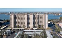 Aerial view of a high-rise building with water and city views at 7050 Sunset S Dr # 211, South Pasadena, FL 33707
