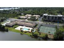 Aerial view of condo community with pool, tennis courts, and waterfront access at 9860 62Nd N Ter # 1013, St Petersburg, FL 33708