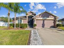 One-story home with a two-car garage and landscaped front yard at 2424 Dakota Rock Dr, Ruskin, FL 33570