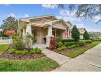 Charming Craftsman style home with a welcoming front porch and landscaped yard at 10002 Bentley Way, Tampa, FL 33626