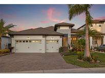 Attractive two-story home with a three-car garage and landscaped yard at 3108 Christophers Watch Ln, Ruskin, FL 33570