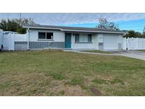 Updated exterior with gray accents and a teal front door at 4617 49Th N Ave, St Petersburg, FL 33714