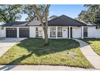 Updated ranch home with modern facade and two-car garage at 7003 Applewood Ct, Tampa, FL 33615
