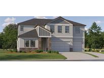 Two-story home with gray siding, stone accents, and a two-car garage at 9717 Runaway Breeze Dr, Land O Lakes, FL 34637