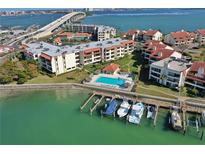 Aerial view of waterfront community with pool, boat slips, and lush landscaping at 106 1St E St # 115, St Petersburg, FL 33715