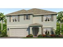 Two-story house with light-green exterior, gray roof, and a two-car garage at 12125 Mountain Island Trl, Parrish, FL 34219