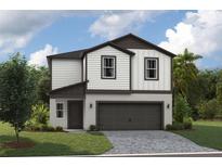 Two-story house with dark brown accents and a two-car garage at 37306 Sagemoor Dr, Zephyrhills, FL 33541