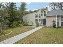 Inviting exterior with a walkway leading to the entrance and a small, well-maintained lawn at 9412 Forest Hills Cir, Tampa, FL 33612
