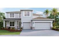 Two-story house with gray siding, stone accents, and a two-car garage at 16023 10Th E Ave, Bradenton, FL 34212