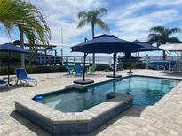 Inviting pool and spa with patio furniture, offering relaxing waterfront views at 1643 Sea Breeze Dr, Tarpon Springs, FL 34689
