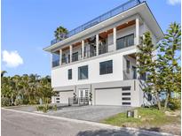Stunning modern home with three-car garage and multiple balconies at 18077 3Rd St, Redington Shores, FL 33708