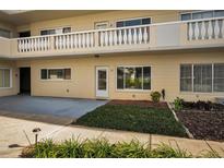 Attractive two-story building with a well-manicured lawn and shrubbery in front of the entrance of unit 11 at 2221 Swedish Dr # 11, Clearwater, FL 33763