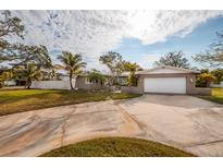 House exterior with a driveway, landscaping, and garage at 4317 Overlook Ne Dr, St Petersburg, FL 33703