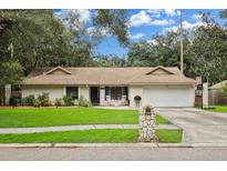 Charming single-story home with a well-maintained lawn and attached garage at 6402 E 113Th Ave, Tampa, FL 33617