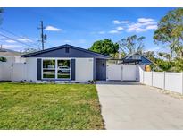 Newly renovated home with modern exterior, fresh landscaping, and a paved driveway at 916 17Th N St, St Petersburg, FL 33713