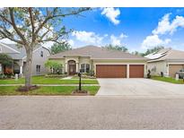 Beautiful home with 3-car garage, well-manicured lawn and landscaping at 11807 Summer Springs Dr, Riverview, FL 33579