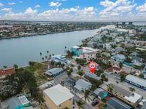 Aerial view of a house near the water, showing the surrounding neighborhood at 130 90Th Ave, Treasure Island, FL 33706