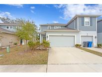 Two-story townhome with gray exterior and attached garage at 2146 Laceflower Dr, Brandon, FL 33510