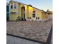 Beautiful yellow house with a large paver driveway at 316 16Th Ave, Indian Rocks Beach, FL 33785