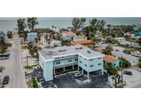 Aerial view of teal building near beach, ample parking at 8200 Bayshore Dr # 1, Treasure Island, FL 33706