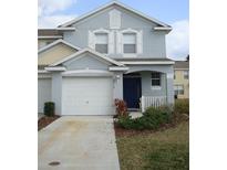 Two-story house with gray siding, white garage door, and blue front door at 9715 Carlsdale Dr, Riverview, FL 33578
