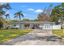 Charming single-story home with a spacious front yard and a long driveway at 112 K St, Clearwater, FL 33759