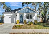 Charming craftsman style home with white siding and a blue roof at 3206 E 38Th Ave, Tampa, FL 33610
