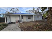 Newly painted house with a carport and landscaping at 5005 Drift Tide Dr, New Port Richey, FL 34652
