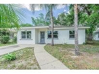 Newly painted single story home with a landscaped yard and walkway at 5218 E 20Th Ave, Tampa, FL 33619