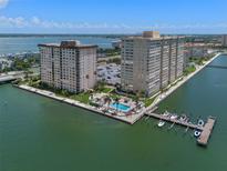 Aerial view of waterfront condo building with pool and boat docks at 5220 Brittany S Dr # 201, St Petersburg, FL 33715