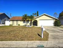 Single-story house with a landscaped lawn and attached garage at 8523 Viva Via Dr, Hudson, FL 34667