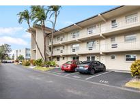 Two-story condo building with parking and tropical landscaping at 9940 47Th N Ave # 120, St Petersburg, FL 33708