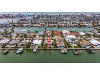 Bird's eye view of a waterfront home surrounded by other houses at 11325 6Th E St, Treasure Island, FL 33706