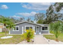 Newly renovated gray house with walkway and tropical landscaping at 1341 Springdale St, Clearwater, FL 33755