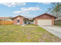 Brick house with 2-car garage, and a well-maintained lawn at 1708 Dove Field Pl, Brandon, FL 33510