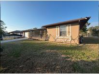 Single-story home with carport and fenced yard at 27064 Omni Ln, Punta Gorda, FL 33983