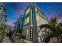 Modern three-story townhome with light teal exterior and private patio at 2819 1St S Ave, St Petersburg, FL 33712