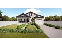 Craftsman style home with a front porch and landscaped yard at 3305 W Oak Ave, Plant City, FL 33563