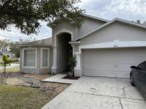 Two-story house with attached garage and landscaping at 6905 Sotra St, Wesley Chapel, FL 33545